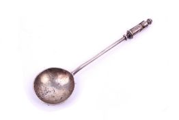 A silver spoon with finial modeled as a peg doll.
