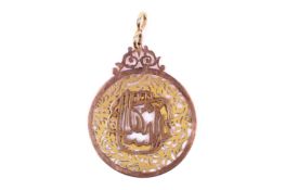 A yellow metal disc pendant. Of decorative pierced form with Arabic cypher to centre.