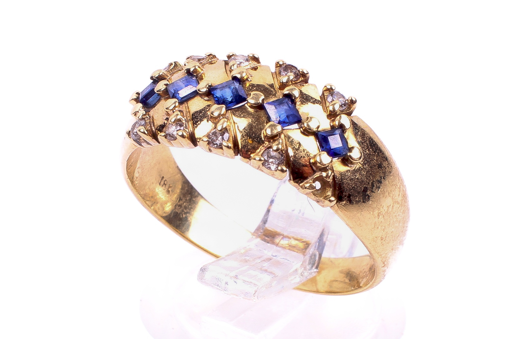 A yellow metal sapphire and diamond set dress ring. Five trap cut sapphires of 0.