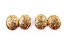 A pair of yellow metal oval cufflinks. Having engraved scrolling decoration, unmarked, L15mm, 6.7g.