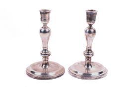 A pair of sterling silver candlesticks by Charles S Green & Co Ltd with loaded bases.