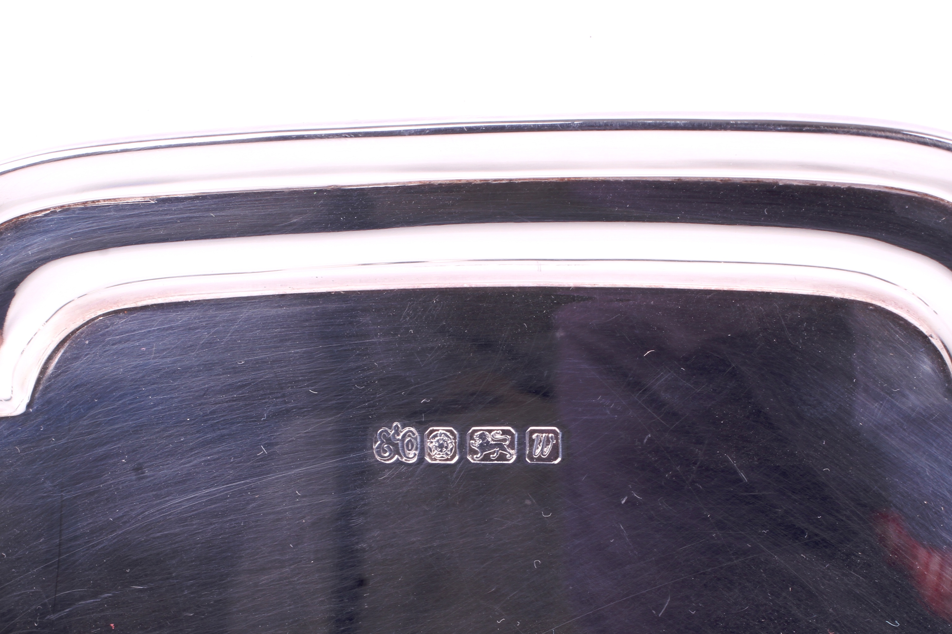 A silver quatrefoil footed tray. With stepped rim, raised on four short scroll feet. - Image 2 of 3