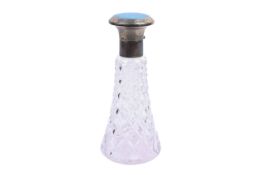 A silver mounted cut glass perfume bottle.