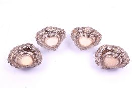 A set of four heart shaped pierced dishes.