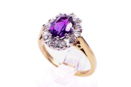 A 18ct gold amethyst and diamond cluster ring.