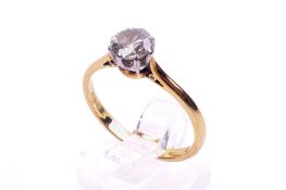 A modern 18ct gold and diamond solitaire ring. The round brilliant approx. 0.