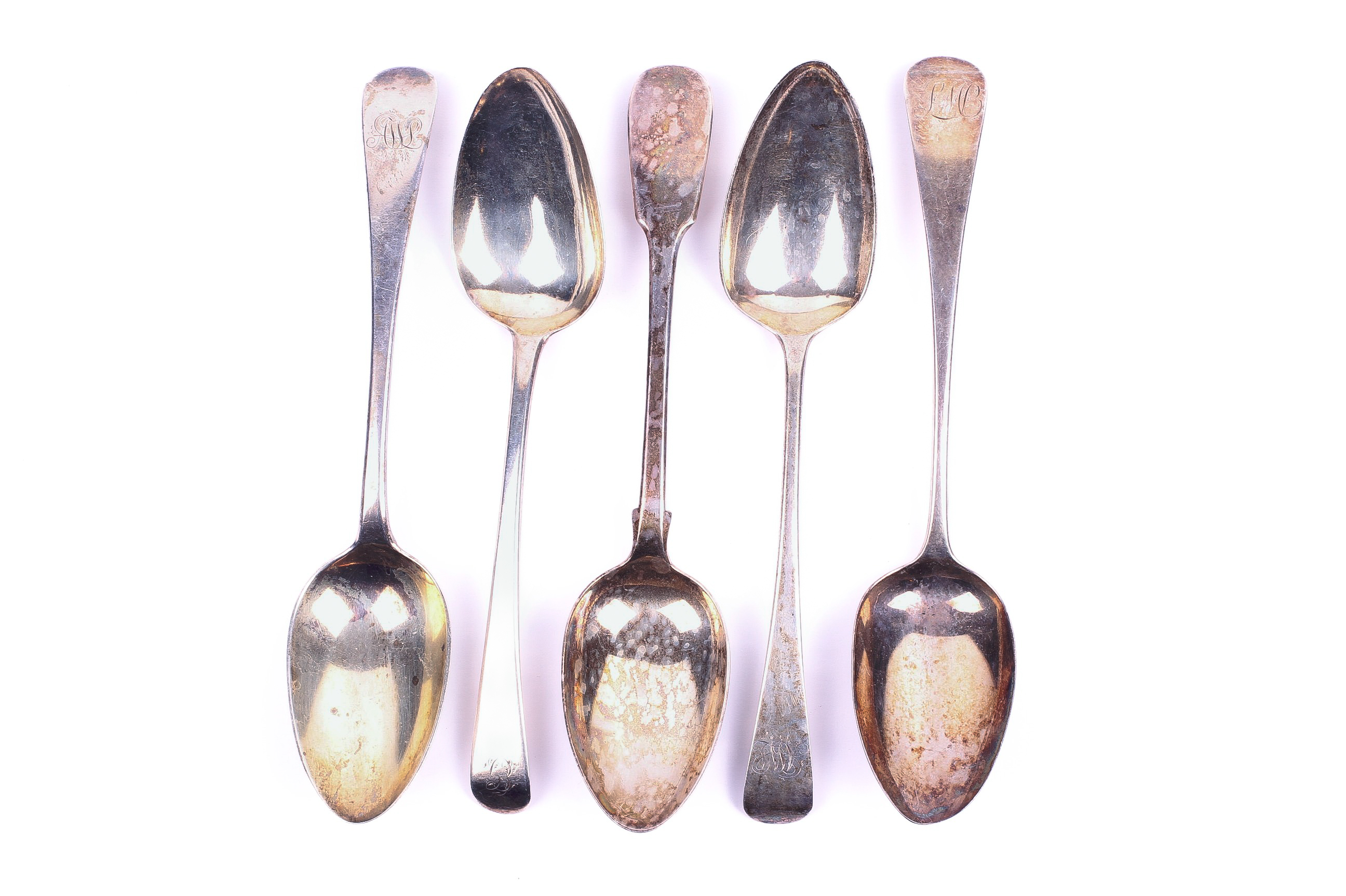 Five 19th century silver serving spoons.