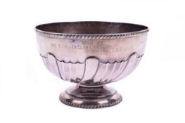 A sterling silver presentation bowl. The lower half with a wavy fluted pattern over a stepped base.