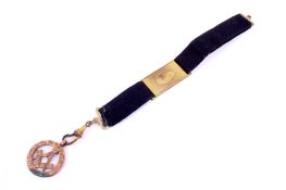 A 9ct gold Masonic medal with square & compass motif.