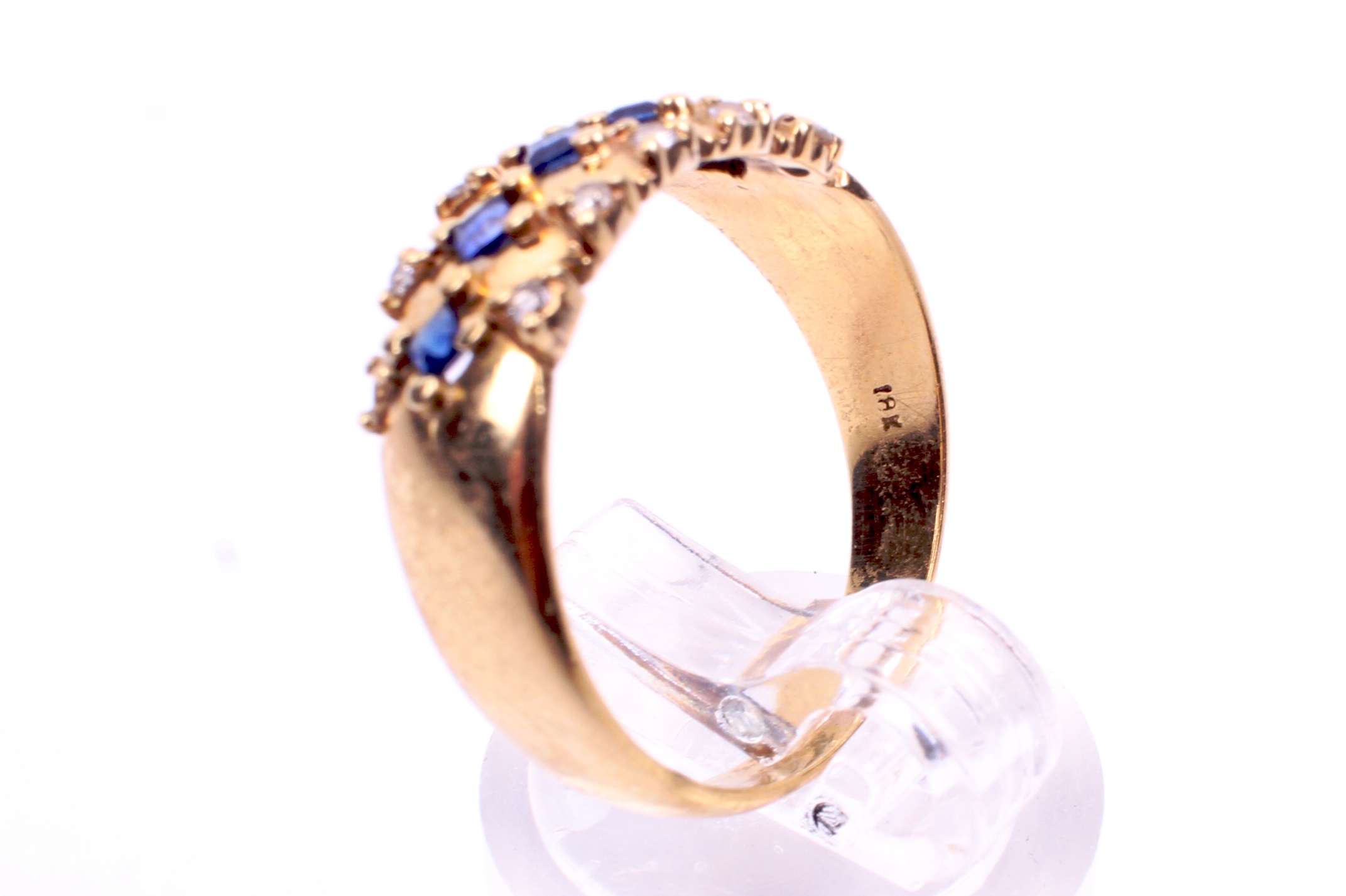 A yellow metal sapphire and diamond set dress ring. Five trap cut sapphires of 0. - Image 4 of 4