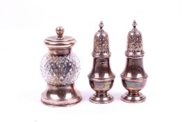 A silver mounted pepper grinder and a pair of pepper pots.