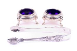 An 1836 silver sugar tongs and a pair of silver salts.
