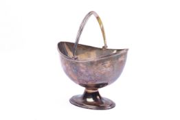 A swing handled silver bowl. With reeded handle over the boat form bowl, raised on a spread foot.