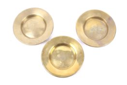 Three brass military dishes. Comprising one engraved with the RAF crest, another 'H.M.S.