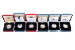 A group of six silver proof £1 coins.