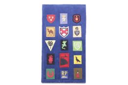 A collection of WWII Cornwall Home Guard cloth badges on a board.
