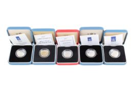 A group of four silver proof £1 coins.