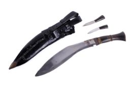 A bone handled kukri. With two additional small knives, in a metal tipped scabbard.
