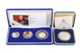 A Silver proof coin set and a silver coin.