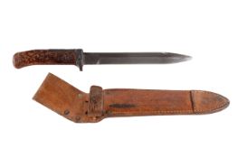 A Czechoslovakian VZ-58 knife bayonet. Marked 73H 19 and 188, blade 17cm, in a leather scabbard.