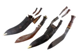 Two kukri knives in scabbards.