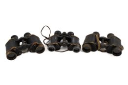 Three pairs of World War period binoculars. Two by Kershaw, one with military arrow.
