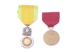 A French military medallion and a US good conduct medal.