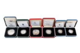 A group of six silver proof coins.