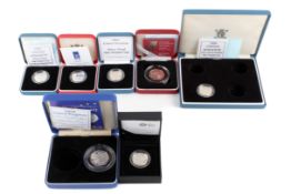 A group of seven assorted modern silver coins.