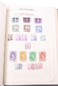 A worldwide collection of stamps in a green Cranbourn album.
