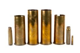 Four Trench Art vases and two shells.