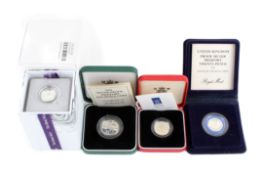 Group of four modern silver coins.