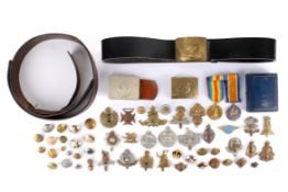 A pair of WWI medals and assorted cap badges, buttons and belt buckles.