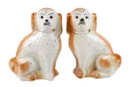 A pair of late Victorian Staffordshire ceramic King Charles spaniel dogs.