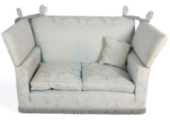 A blue and white upholstered drop end sofa.
