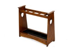An Arts and Crafts oak stick umbrella stand. Having five sections, with a zinc drop-in drip tray.