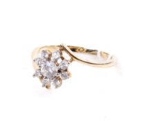 A 9ct gold dress ring. Set with a flower head of colourless stones, size circa Q, weight 2.4g.