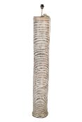 A large contemporary cylinder standard lamp. With a ridged body on a circular base.