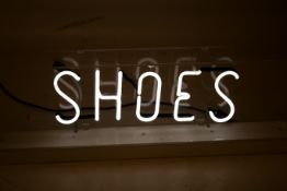 Neon 'Shoes' sign. In a Perspex case. H 36cm W 100cm.