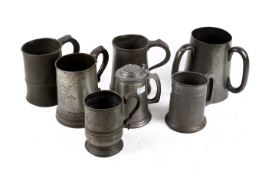 A collection of early 19th century pewter mugs.