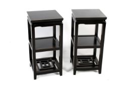 A pair of contemporary Chinese style ebonised side tables. Two shelves under. H 79cm W 38cm.