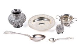A small group of silver and white metal items.