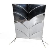A mid-century chrome fireguard.