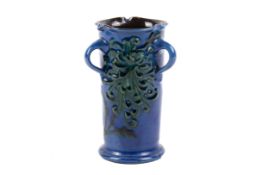 CH Brannam pottery cylinder three handle vase.