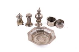 A small group of silver table items.
