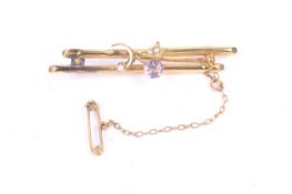 An Edwardian 9ct gold, amethyst and seed pearl bar brooch.