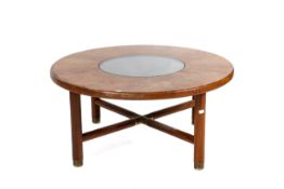 A mid-century circular teak coffee table.
