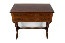 A contemporary mahogany canteen of cutlery table.