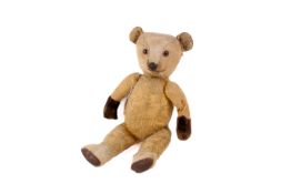 Early 20th century British articulated plush teddy bear 37cm long.