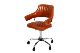 A contemporary orange faux leather adjustable swivel desk chair. With a chrome metal frame and base.